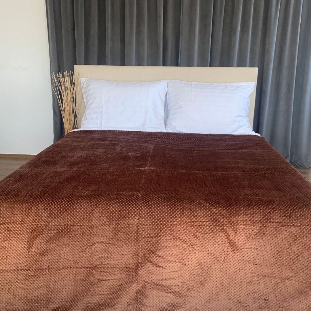 Medium brown polka dot bedspread